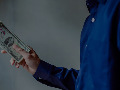 Clutching a wad of cash, the man becomes a visual embodiment of corruption, illustrating the allure and compromise associated with illicit financial gain