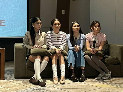 The members of BINI sitting side by side in effortless fashion, representing togetherness rooted in authenticity