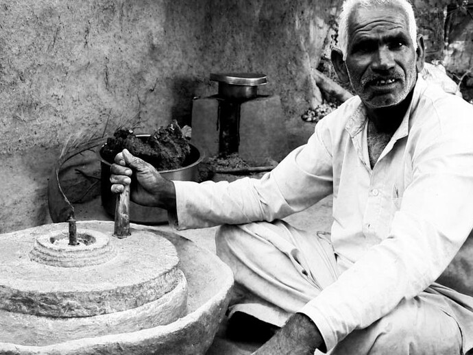 Babu grinds rice, Madhya Pradesh, 2013