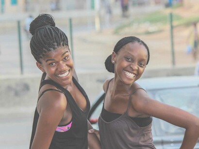 Two black teenagers smiling and enjoying the liberties of life that were made possible by those who strived for justice and equality