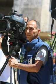 A concerned camera operator filming Gaza, in the Middle East, Asia