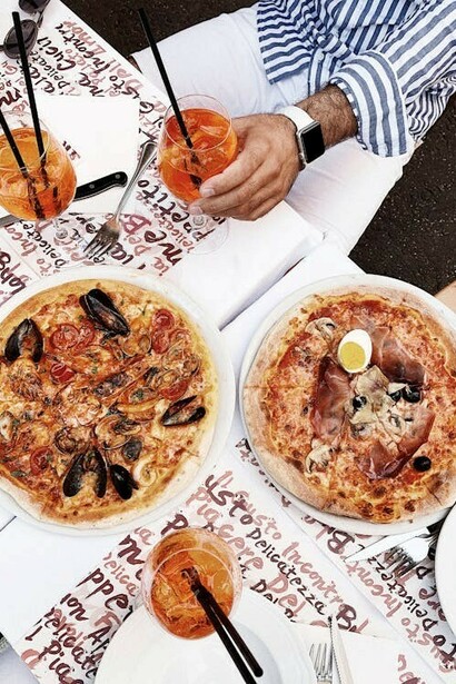 Aerial view of pizzas and drinks arranged on a table in Rome, Lazio, Italy