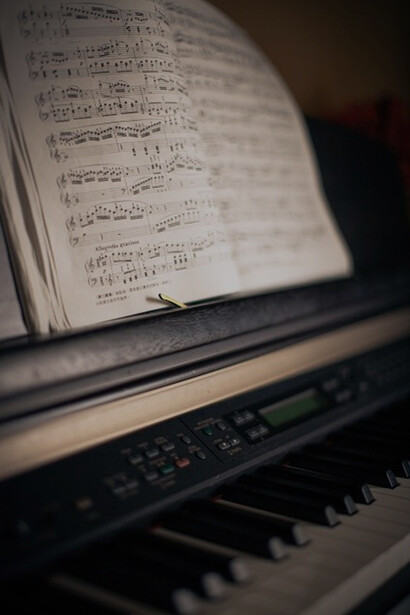 Elegant white musical notes gracefully adorning the sleek black piano keys