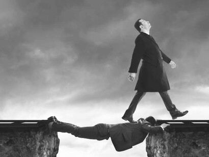 A man manipulating another to form a bridge across a cliff, symbolizing deception in business life