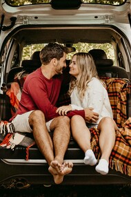 A couple in the trunk of the car are dismissing the talk of marriage and kids on a date