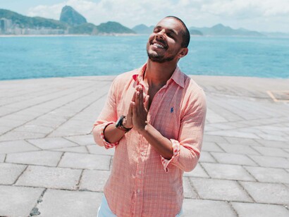 A man bringing his hands together in gratitude as he channels the frequency and energy of self-love