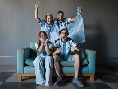 Argentine supporters erupting with emotion during a match, representing the collective passion that comes with the World Cup