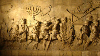 Part of the Arch of Titus, a Roman triumphal arch, depicting Romans carrying The Ark of the Covenant after destruction of the Temple. c. 81 CE