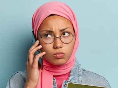 Hijabi student studying with books, showcasing the significance of education in Islam