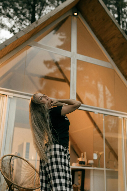 Serene moments at a stylish wooden A-frame cabin in the forest, surrounded by quiet mountain landscapes and reflecting the beauty of offline travel, silent retreats, and slow living