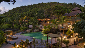 The pool at Constance Lemuria in Praslin, Seychelles, offers a serene space surrounded by lush tropical greenery