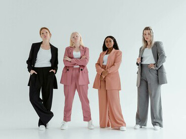 Women in business coats on a white background