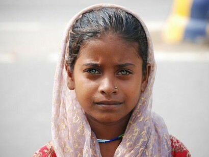 A little Indian girl, staring into the camera. Dal is a staple in every Indian kitchen, the dishes that originate from all these kitchens can be vivid variants