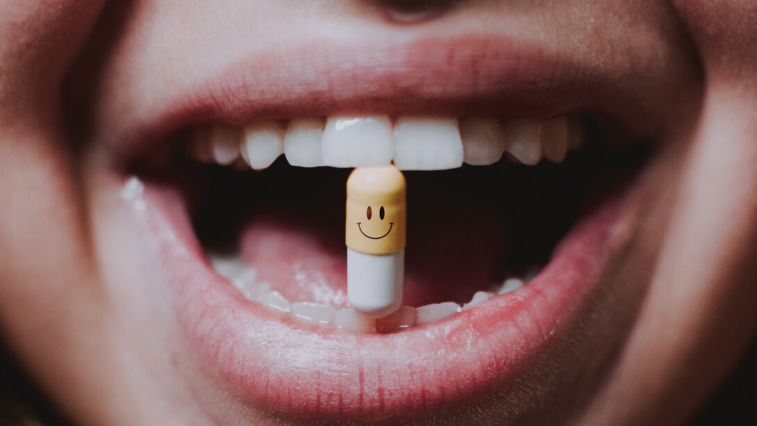A woman gracefully takes her medication, swallowing it with ease and assurance