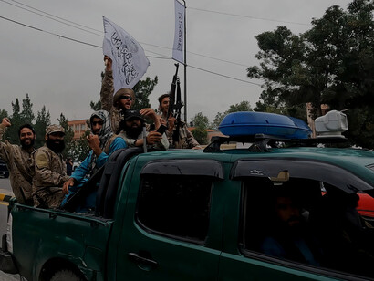 Taliban fighters patrol in a captured Humvee in the days following Kabul’s collapse in August 2021