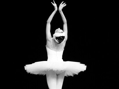 Ballerina with her hands up in the air