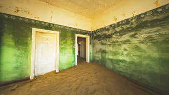 Doorways through time in an abandoned house in Kolmanskop, Namibia, photographed by Francesco Ungaro