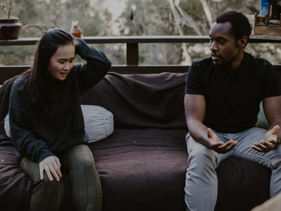A woman looking distressed as her husband argues
