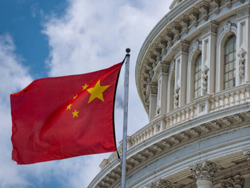 The flags of the United States and China fly over the White House, symbolizing the complex dynamics of diplomacy, diplomatic sanctions, and embargoes between the two nations