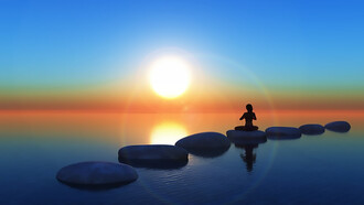 Meditating on sunlit rocks, a person embraces tranquility and connection with nature