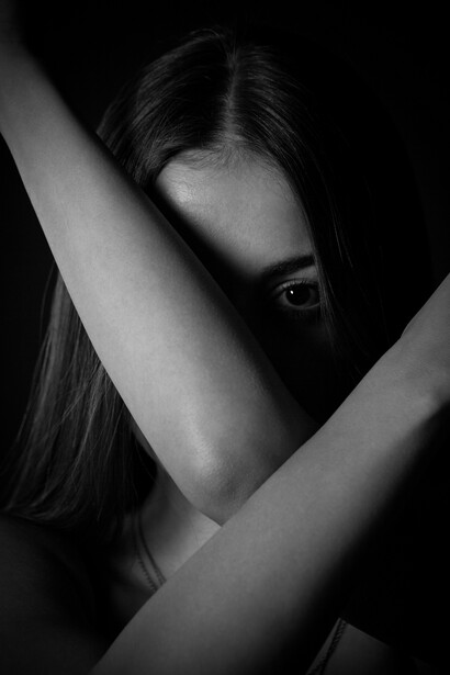 Grayscale photo of a young girl crying, her face reflecting deep sadness and depression