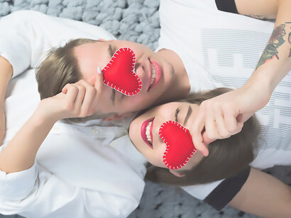 A couple reclining amidst tiny heart symbols, capturing affection and closeness