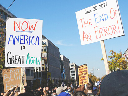 Street celebration following Trump's defeat in 2020, with banners reading 'The End of an Error'