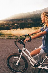 A woman riding her Bup-up bike on her back into town