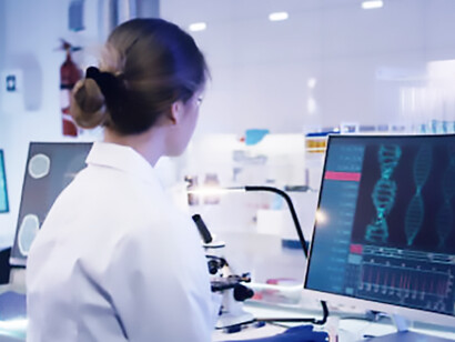 A multi-ethnic group of researchers investigates DNA mutations, with a female scientist prominently engaged in the foreground