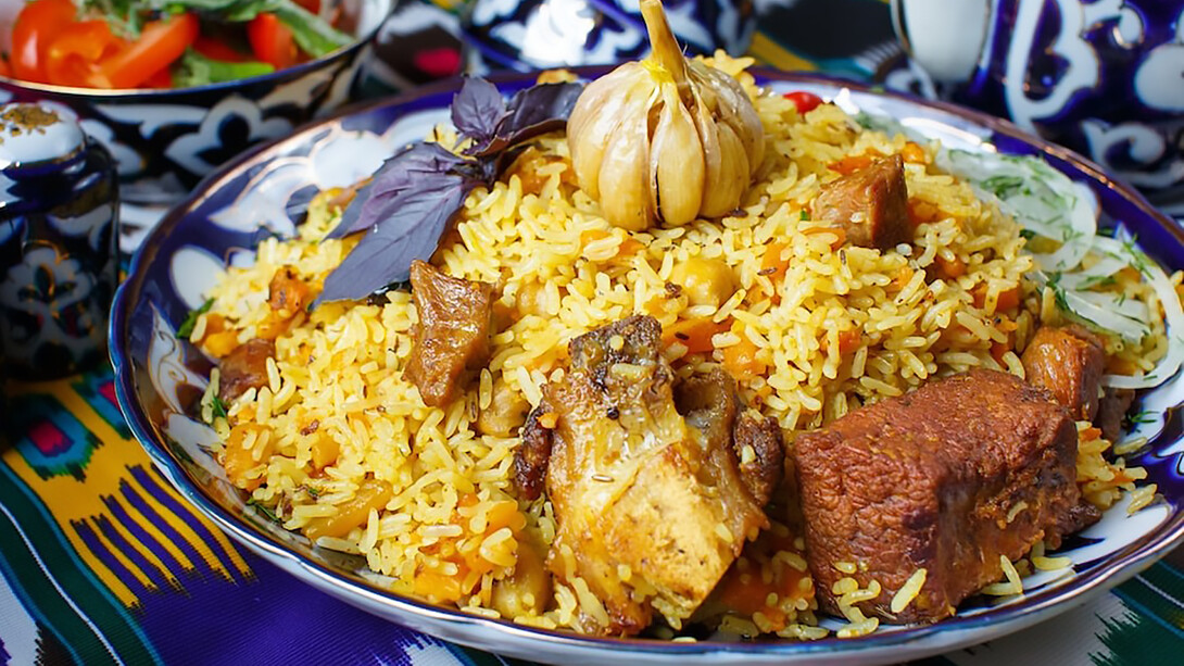 A plate of rice with meat and vegetables