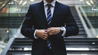 An image of an anonymous capitalist getting ready to conduct financial transactions