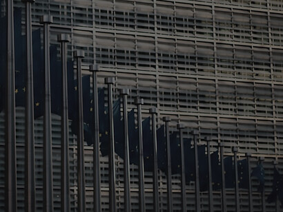 In Brussels, Belgium, the European Union flags wave in front of the Berlaymont building, representing the collaborative efforts of member states