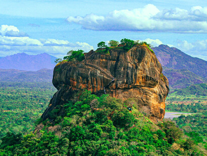 Sigiriya, the ancient Lion Rock fortress, rises dramatically above Sri Lanka’s central plains