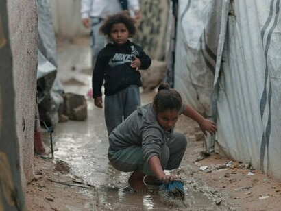 Two young children in a confined settlement, highlighting the stark contrast between global optimism and realities
