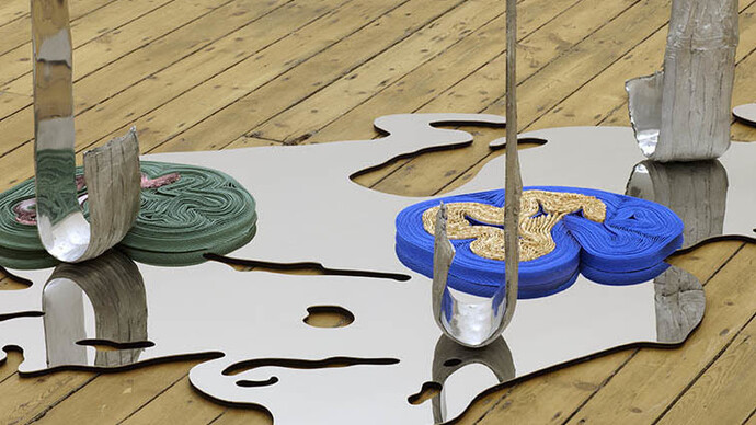 Alice Channer, Deepwater Horizon, 2014, Mirror polished and laser cut stainless steel, Super-Matt laquered and laser cut stainless steel, Cast and mirror polished aluminium, Accordion pleated snake skin heat-embossed stretch polyester, Stretch alligator print maxi-skirt, Pelletised HDPE, Stretch snake print vest top, 150 x 437.5 x 114 cm (59 x 172 3/16 x 44 7/8 inches), FXP Photography, London, Courtesy of The Approach, London
