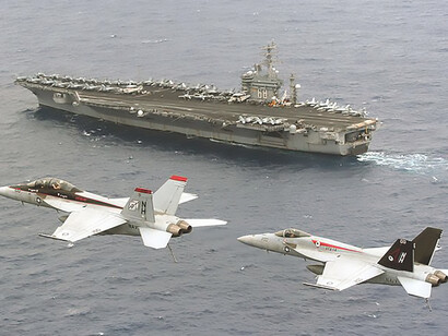 Captains Manazir and Woods, joined by Cmdr. Downing, conduct airborne change of command for CVW-11, piloting F/A-18E and F/A-18F Super Hornets near USS Nimitz (CVN 68)