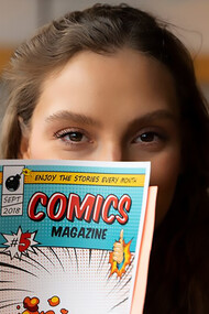 Woman reading comics in a cafe