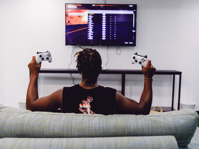 Hombre sujeta dos mandos de un videojuego
