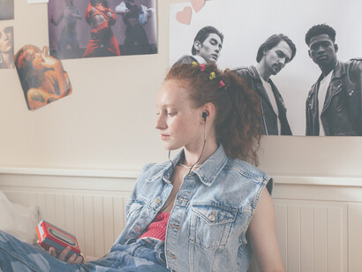 Walkman. Ragazza ascolta della musica al walkman con gli auricolari