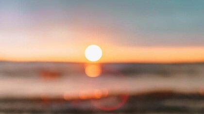 A beach during sunset represents freedom from cages we sometimes build for our fondest memories
