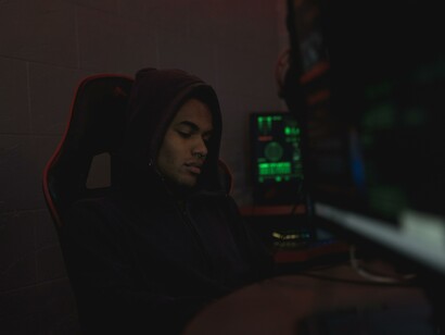 A person sat alone at a computer 