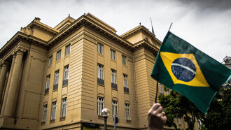Protesters gather outside the government building in Brazil, calling for global action to eradicate hunger and advocate for social programs like Bolsa Família, which have significantly improved the lives of millions