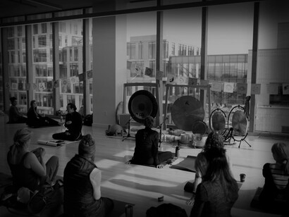 A breathwork class of students, using gongs for focus