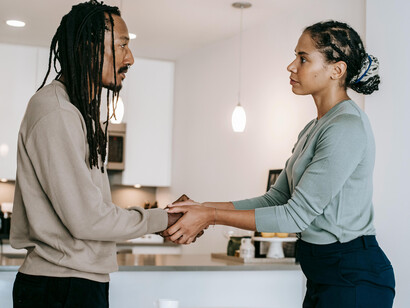 A woman calmly holding a man's hands