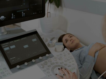 A woman laying down as she goes through an ultrasound 