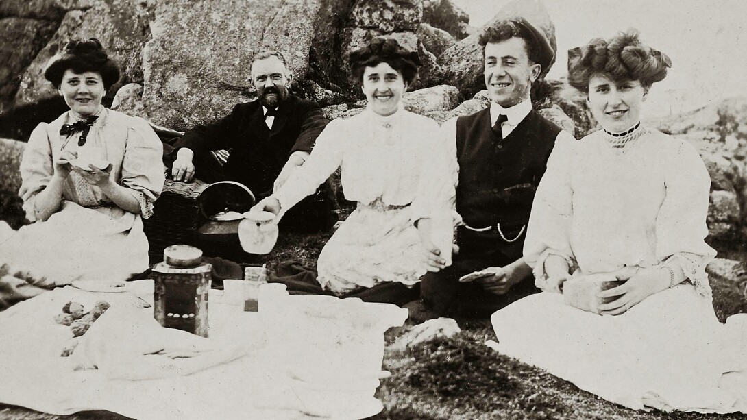 An old photo of friends at a picnic having tea