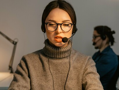 A help desk professional communicating through a headset, reflecting the trusted point of contact that can be exploited through social engineering