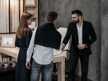 A professional handshake marking the start of a constructive conversation, representing the value of dialogue in building trust and cooperation