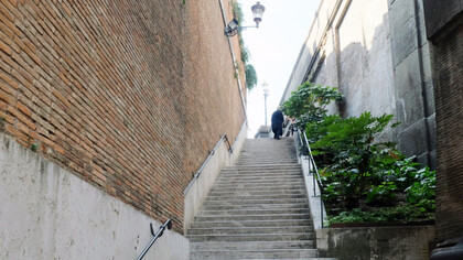 A man walking up countless steps 