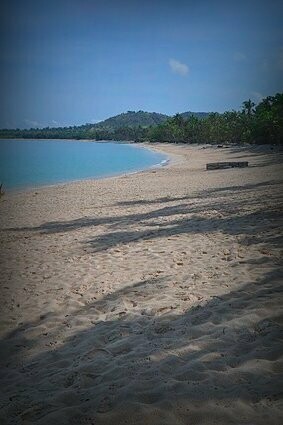 Sunny day and tree shade in Saud Beach, Pagudpud, Philippines 